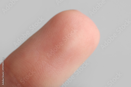 Картината върху платно Human fingertip on grey background