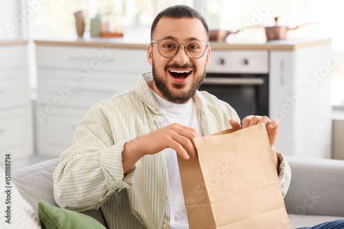 Happy young man with paper ...