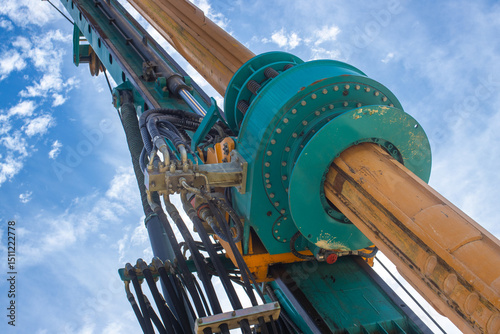 Excavator boom and hydraulic system, this system allows drilling large vertical and inclined holes for various purposes such as pole mounting, well drilling