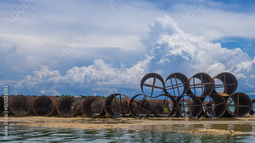 metal casing pipes of large diameter, stacked.  They are used in bridge construction, in particular, for drilling piles in difficult geological conditions, including underwater drilling