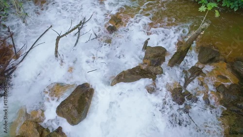 Top-down view of clean river water flowing over rocks near Barrick Gold mine in Cotuí, Dominican Republic photo