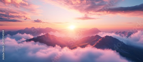 Sunrise over mountains shrouded in clouds