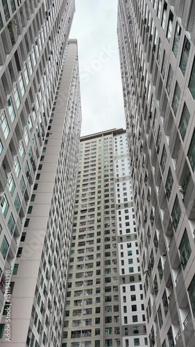 Vietnam, Nha Trang - 29.05.2025 - Skyscrapers, view from the bottom up, large buildings, man, high-rise building in Asia, luxury residential complex Oceanus, Muntian