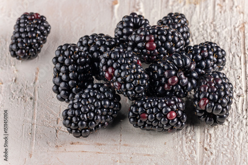 Fresh Ripe Blackberries on rustic light wooden background - macro close-up