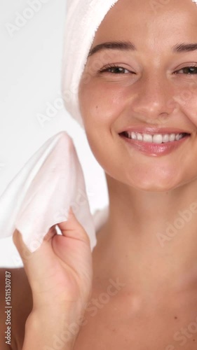 Cheerful Woman Wipes Off Makeup Using Napkin in Skincare Routine