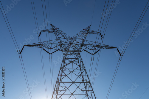 Fényképezés Low angle view of a high voltage electrical pylon and power lines against a clea