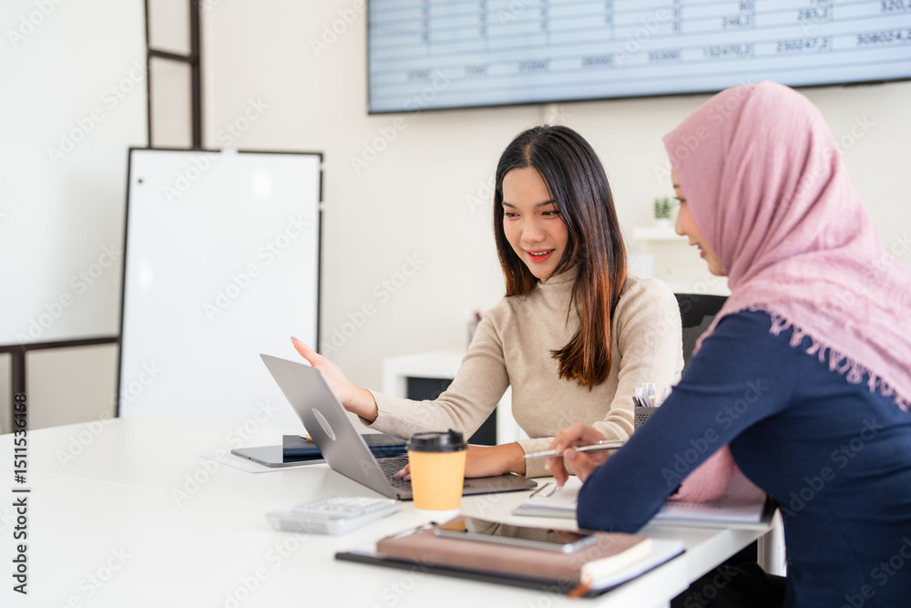 © Fahng - Discussion with colleague. Beautiful asian businesswoman wearing hijab while working at open space or office. Concept of occupation, freedom in business area, leadership, success, . © Fahng - Discussion with colleague. Beautiful asian businesswoman wearing hijab while working at open space or office. Concept of occupation, freedom in business area, leadership, success, .