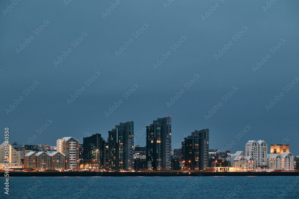 Fototapeta premium Reykjavik city skyline illuminating the dusk sky in iceland