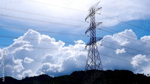 Power Lines in the Sky: A towering power pylon reaching towards the expansive sky, its silhouette contrasting against the backdrop of fluffy clouds.