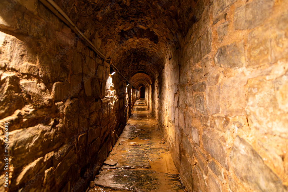 Obraz premium Illuminated Roman Cloaca (Sewer) Tunnel in Astorga. Castile and Leon, Spain