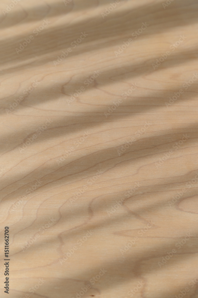 Fototapeta premium Natural warm wood texture features diagonal shadows and parallel light stripes creating an abstract background pattern on smooth brown surface. detail shows subtle wood grain of organic material