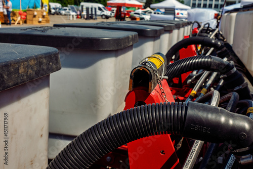 Close-up view of a seeder with black hoses and white tanks Agricultural machinery equipment