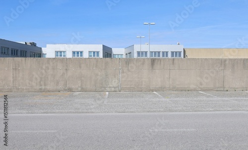 Wallpaper Mural Concrete surrounding wall with industrial building and sky on behind. Street in front. Background for copy space.  Torontodigital.ca