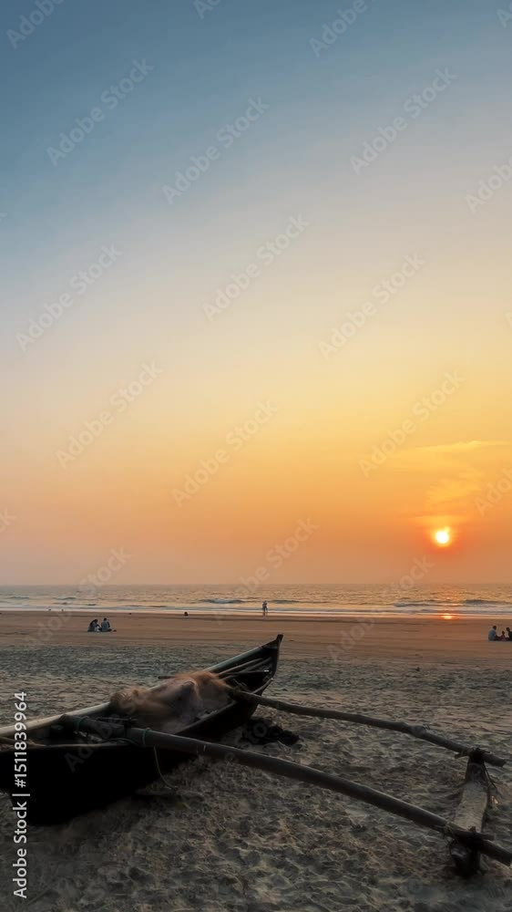 A sunset at a beach in Goa with an abandoned boar in the foreground. Colour corrected and edited with a slow zoom in effect. Ready to use clip for reels, youtube shorts and tiktok