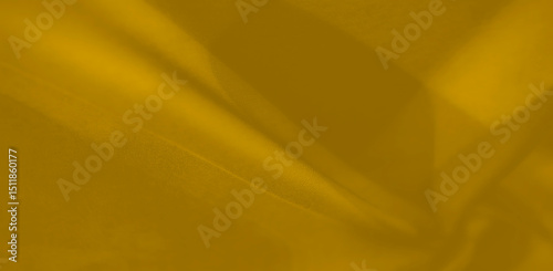 Canvas Print A gracefully draped piece of golden fabric flows in soft folds and gentle shadows, radiating a serene warmth