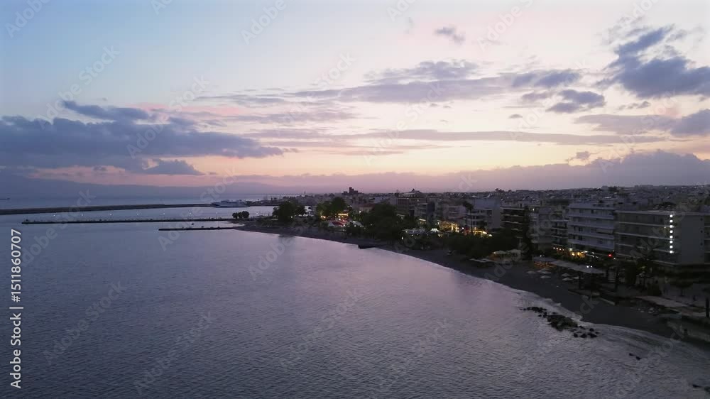 Aerial establishing shot, fast raise up and right slide drone movement, revealing Kalamata cityscape, beautiful cloudy sunset on background 4K