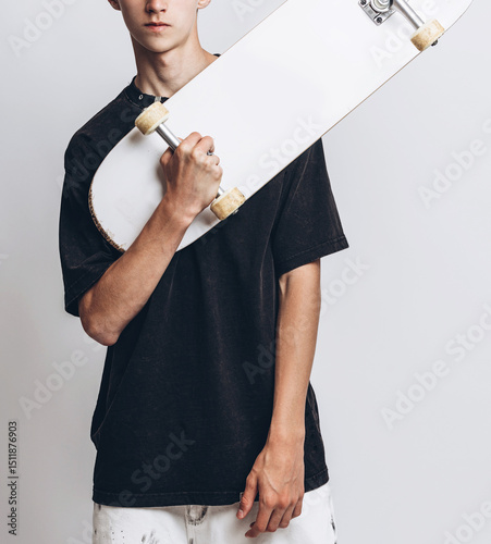 Skate & Style: Teen Energy with Urban Vibes. Teen Boy with Skateboard Posing in Studio on White Background