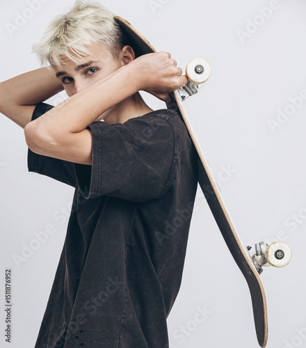 Skate & Style: Teen Energy with Urban Vibes. Teen Boy with Skateboard Posing in Studio on White Background