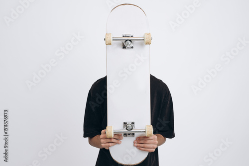 Skate & Style: Teen Energy with Urban Vibes. Teen Boy with Skateboard Posing in Studio on White Background