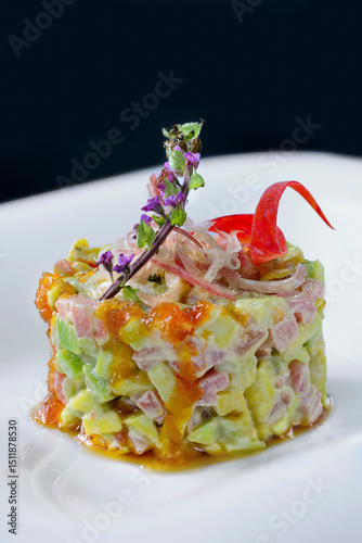 This image showcases a visually striking and gourmet-style dish, likely a tuna tartare or poke-style stack. The dish is composed of finely diced ingredients, 