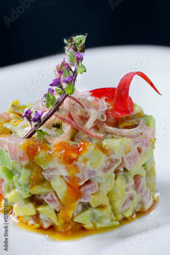This image showcases a visually striking and gourmet-style dish, likely a tuna tartare or poke-style stack. The dish is composed of finely diced ingredients, 