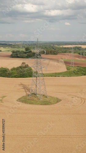 Overhead drone footage of power line structure. Vertical video.