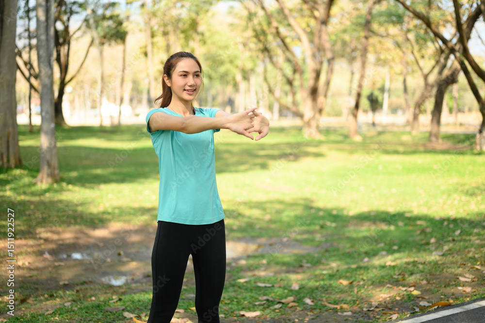 Young Asian Woman Stretching in Park for Morning Workout, Outdoor Fitness and Wellness Young Asian Woman Stretching in Park for Morning Workout, Outdoor Fitness and Wellness