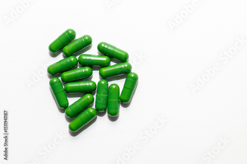 A cluster of vibrant green capsules, arranged on a clean white background.