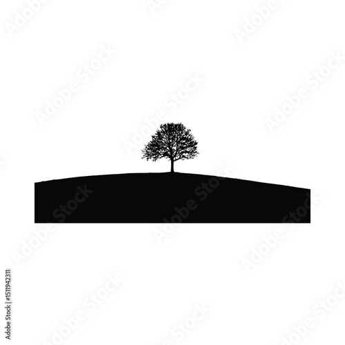 Solitary tree on hilltop silhouette