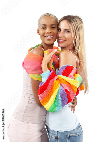 Joyful and loving LGBTQ lesbian couple hugging, standing isolated on white background, wearing rainbow pride flag themed clothing. Concept of love, diversity, inclusion, and support for equal rights