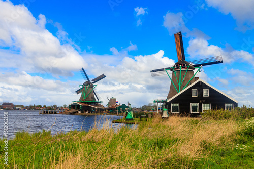 Traditional dutch windmills at the Zaan river in Zaanse Schans village, Netherlands