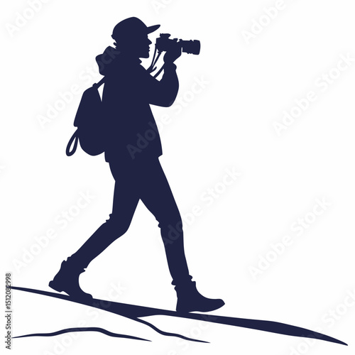 Photographer silhouette walking on hillside