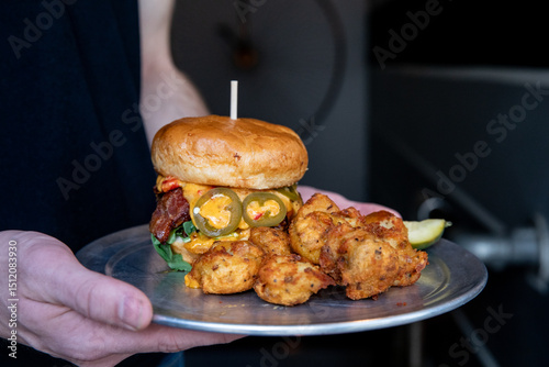 Burger with cheese and bacon with a side of tater tots 