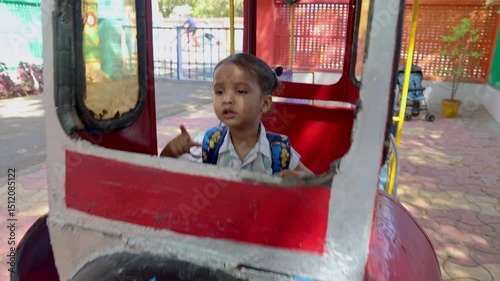 toddler enjoying dummy train at outdoor preschool activity