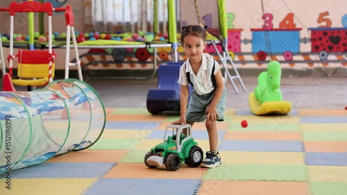 indian preschool child having fun with toys during indoor play