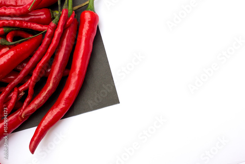 Fototapeta Naklejka Na Ścianę i Meble -  Fresh red chillies and red curly chillies isolated on white background.