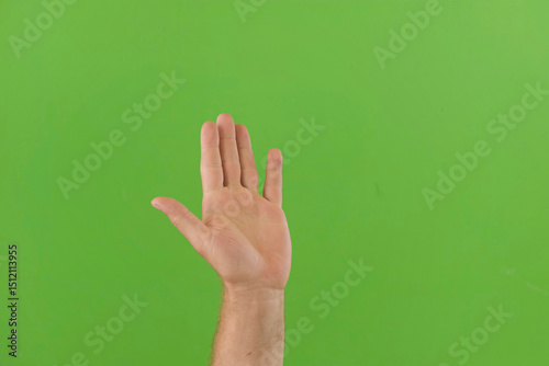 Waving Hand Emoji. Man Gesturing Hello, Hi, Bye. Male Hand Showing Sign of Greeting or Goodbye. Isolate Chroma Key Green Screen Background. Body Language. Close Up. Isolated Emoticon Gesture. Saluting