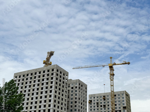 Construction crane on Housing. Building site with cranes against sky. Tower crane on formworks. Crane and building construction. Construction site, Multi Storey Residential Buildings construction. 