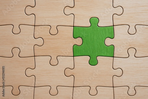 A strategic decision is symbolized by a green puzzle piece fitting into a wooden board representing business growth and effective problem-solving photo