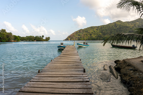Spectacular landscape of the village and bay of Sapzurro in Chocó, Colombia, with a landing stage and boats in the Caribbean Sea.