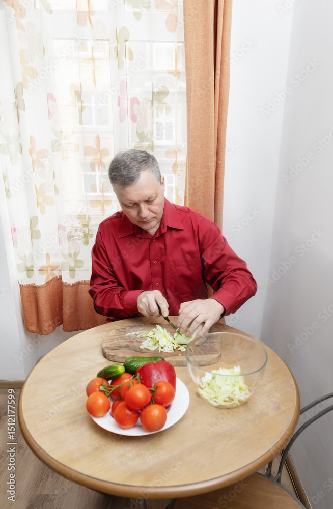 a man prepares a vegetable salad in his kitchen a man prepares a vegetable salad in his kitchen