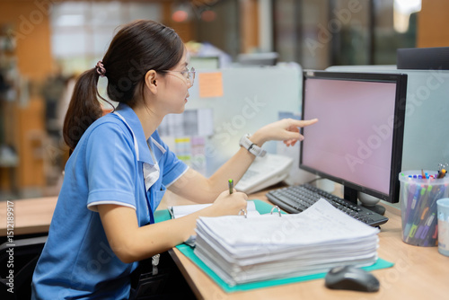 The female employee downloaded the latest business document from the cloud, edited it with suggestions from the team, and saved the updated file on the company’s computer...