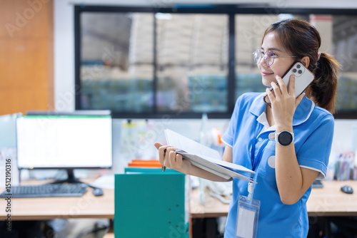 With strong attention to detail, the Asian female employee contributed to strategic planning sessions in the office while monitoring export schedules from the industrial plant.