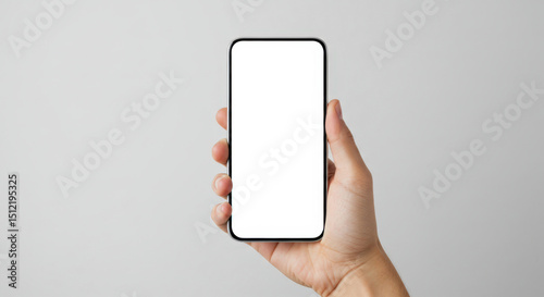 Hand holding smartphone with blank screen against neutral background   photo