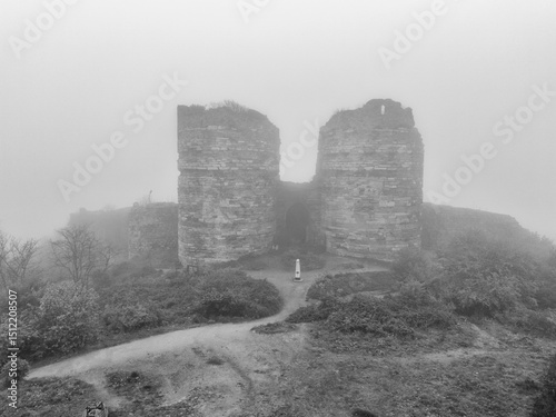 Misty Ruins of an Ancient Fortress. A grayscale image of a misty hilltop with the remnants of a two-towered fortress. Yoros Castle Beykoz Istanbul Turkiye Turkey Anadolu Kavagi  photo