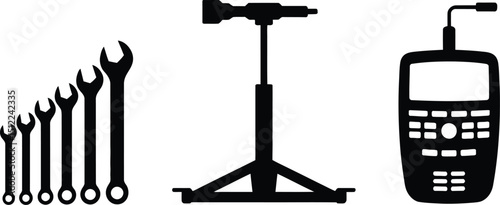 A black and white illustration of wrenches, a jack stand, and a walkie talkie on a white background