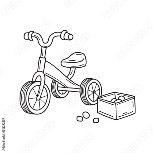 A tricycle parked beside a toy box with toys scattered