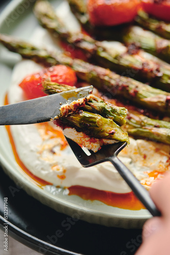 Roasted Asparagus with Creamy Yogurt, Tomatoes, and Herbs on fork