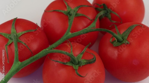 Fresh tomatoes on a vine showcasing vibrant red color