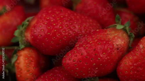 Vibrant strawberries glistening in sunlight at a local market